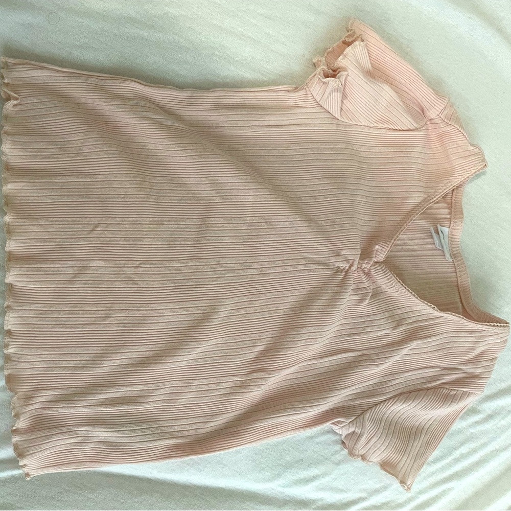 Pink shirt with a scrunched neck piece, laced straps around the head hole.